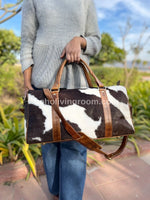 tricolor black, brown, white cowhide travel bag. weekender duffel for style & function. built to last, travel in comfort.