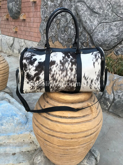 Cowhide weekender bag: rugged elegance, spacious and durable for getaways.