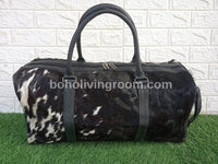 Unleash your adventurous spirit with this cowhide duffle bag, your perfect travel companion.