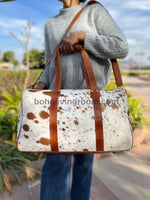 Travel in sophistication with a sleek cow fur weekender bag, designed to meet your travel needs.