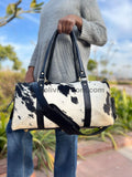 Make a bold statement with this cowhide overnight bag, designed for those who dare to stand out.