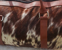 Embark on a journey of discovery with this cowhide duffle bag, your trusted companion for every adventure.