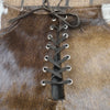 Brown and white lace up cowhide shorts for women. High waist western cowhide shorts that pair well with boots, tanks, or fringe tops for rodeo-ready outfits.

