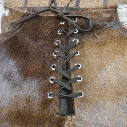 Brown and white lace up cowhide shorts for women. High waist western cowhide shorts that pair well with boots, tanks, or fringe tops for rodeo-ready outfits.

