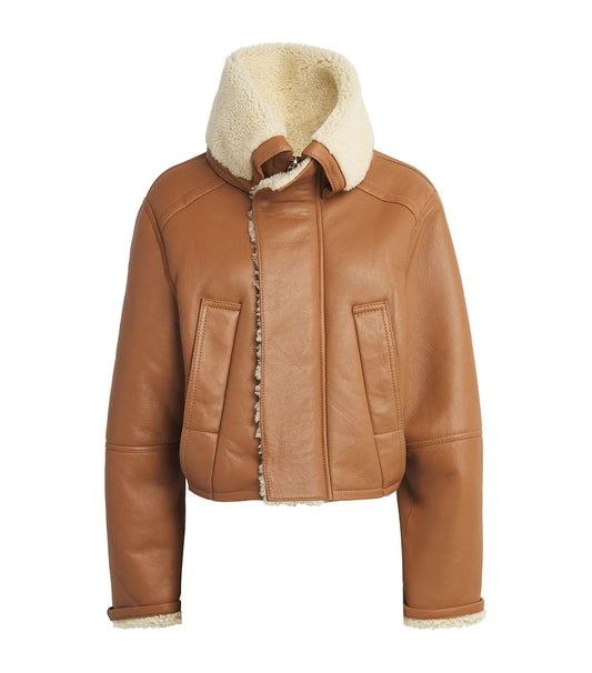 Stylish genuine leather coat on a hanger, showcasing smooth texture and elegant craftsmanship.