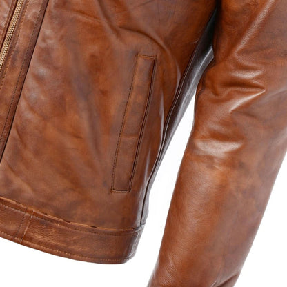 Brown leather jacket and vest combo with intricate stitching, displayed on a mannequin in a showroom.