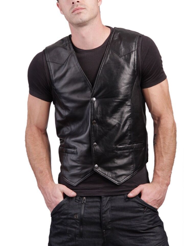 Close-up of a leather motorcycle vest with zippered pockets and detailed stitching, hanging on a rack.