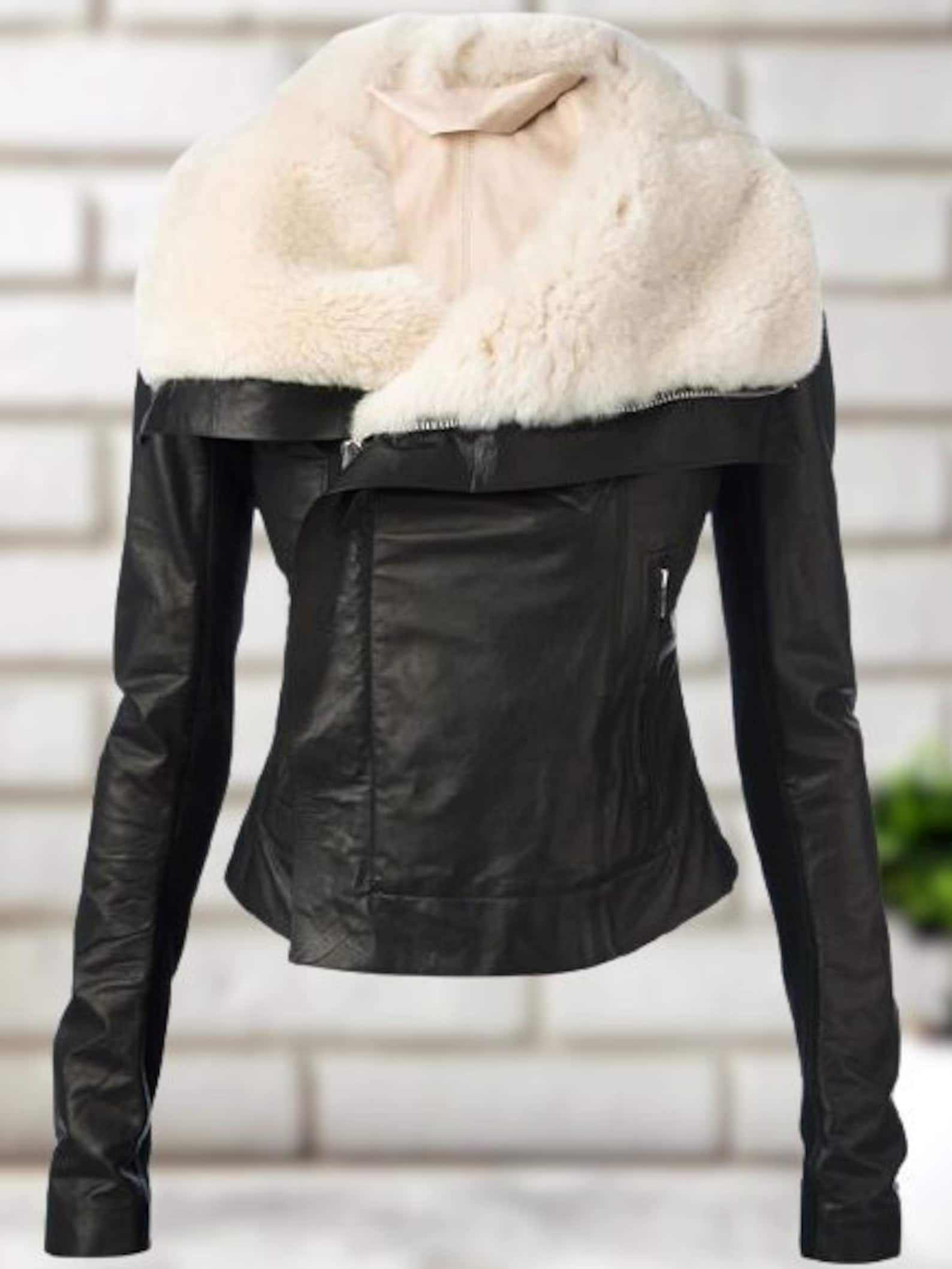 Trendy women's leather jacket draped over a chair, highlighting its soft texture and modern style