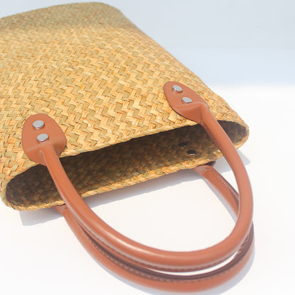 Natural straw beach tote with brown leather handles