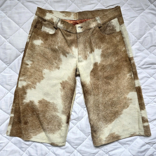 Men’s cowhide shorts made from genuine cow skin offer a raw, natural look with deep texture and distinct brown-white spotting in every piece.