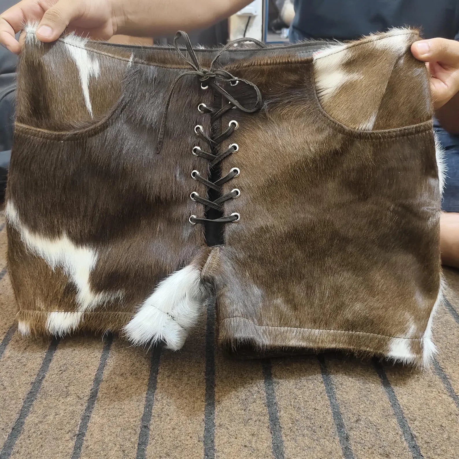Lace cow print shorts in mini cut for women. Cowhide shorts with raw hem and authentic leather hide—ideal for country girls, rodeo nights, and western looks.


