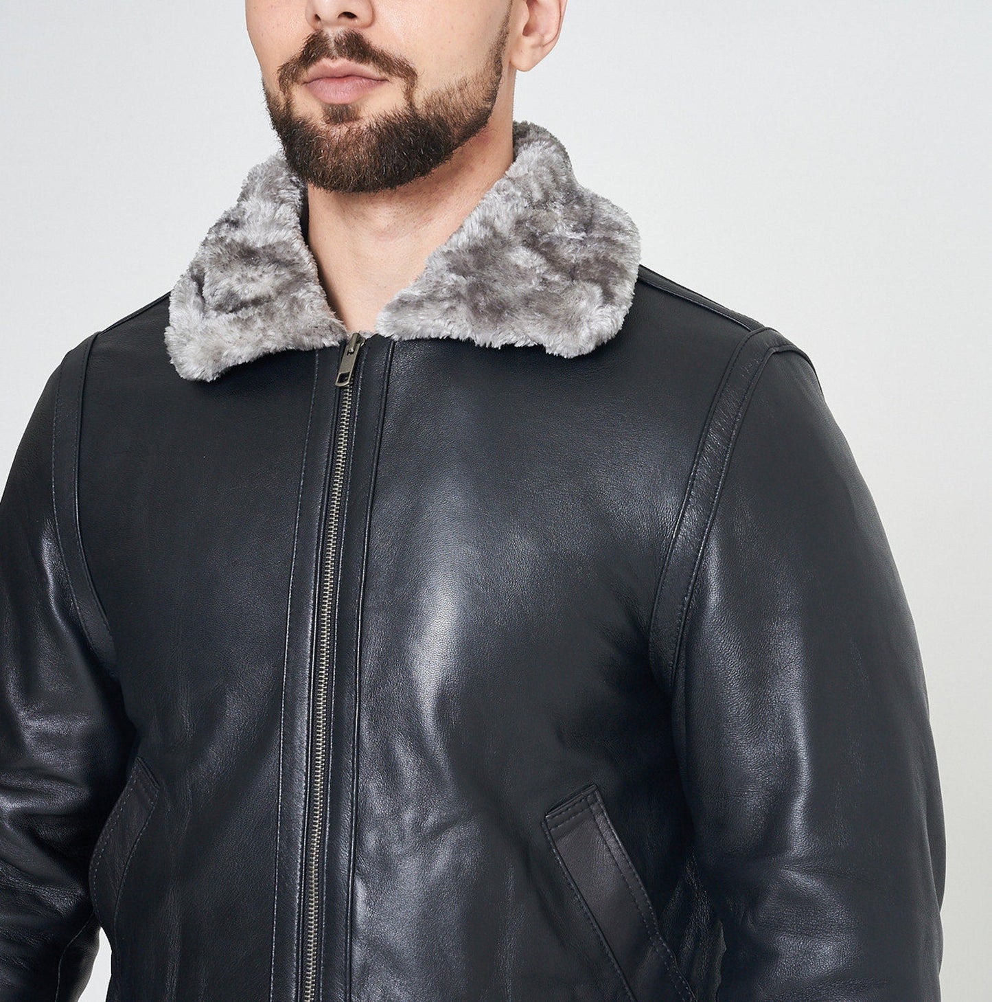 Tan leather fur jacket with a cozy fur lining, perfect for cold-weather wear.