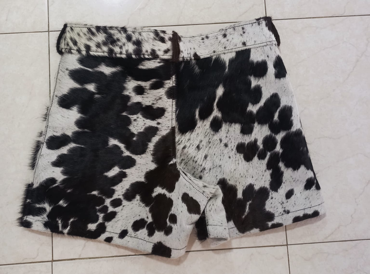 Shop men cowhide leather shorts and cow fur shorts for women in tricolor hide. Real hair-on cowhide with deep pockets and raw texture. 