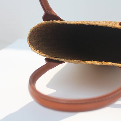 Natural straw beach tote with brown leather handles