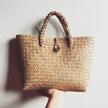 Handwoven seagrass rattan bag with natural braided handles. A unique summer bag perfect for beach days, markets, and casual outings.