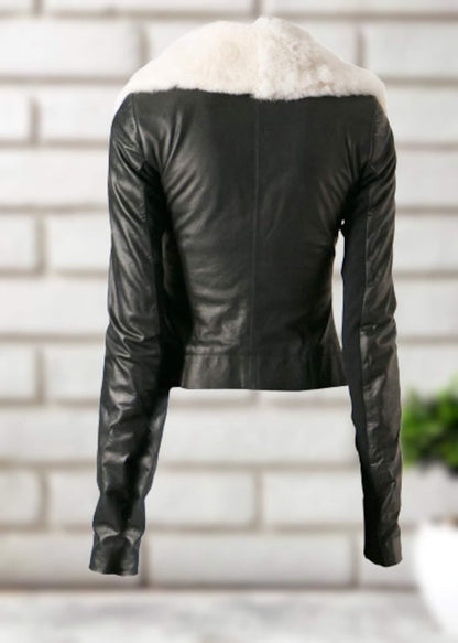 Stylish women's leather jacket hanging against a neutral background, showcasing its refined details and fit.