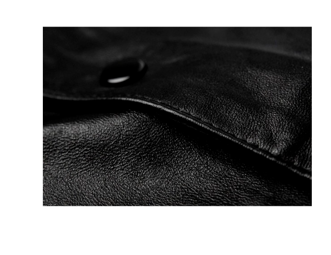 Close-up of a classic black leather vest with a V-neck design and snap-button closures.