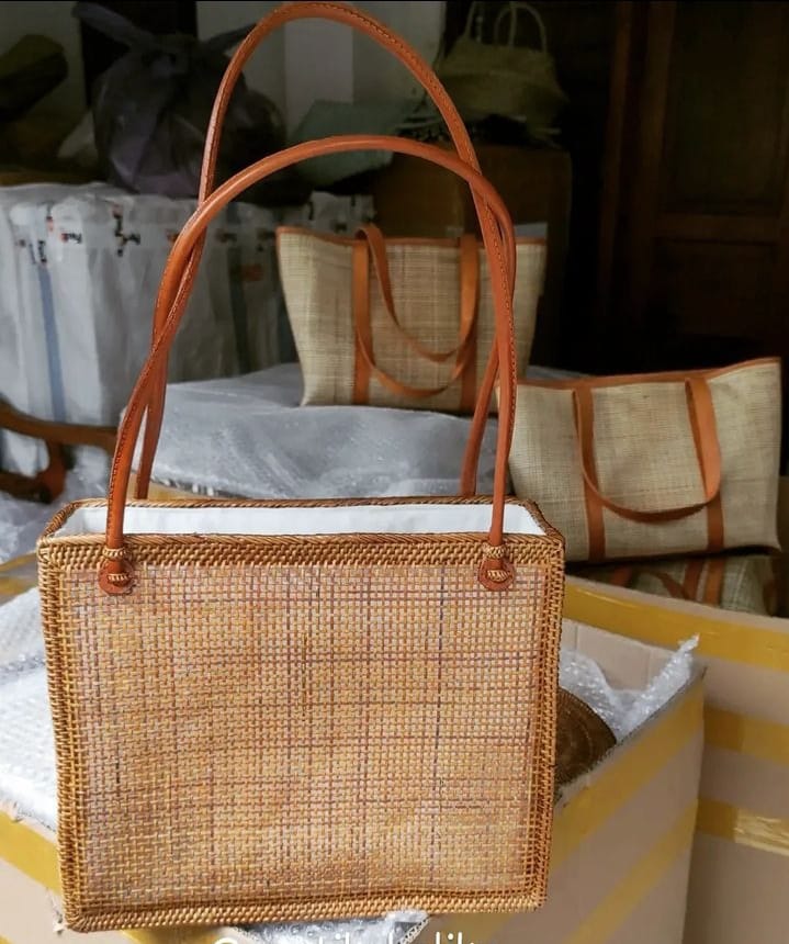 Handcrafted rattan tote with durable handles, offering a spacious design for all your essentials. A blend of natural materials and functionality for your daily carry needs.