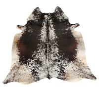 Add a touch of uniqueness to your decor with our mini cowhide rug showcasing a distinctive dark brown and black spotted pattern. Experience the comfort of its softness and smoothness.