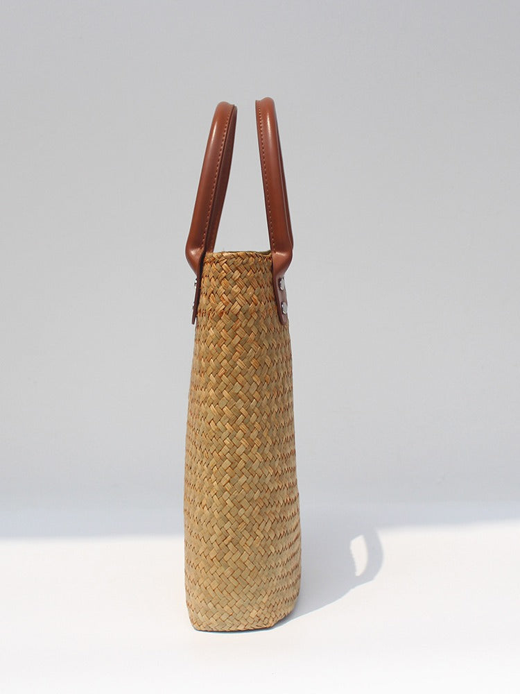 Natural straw beach tote with brown leather handles