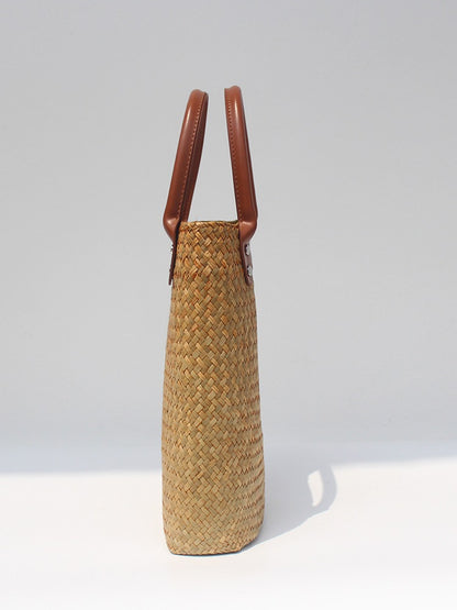 Natural straw beach tote with brown leather handles