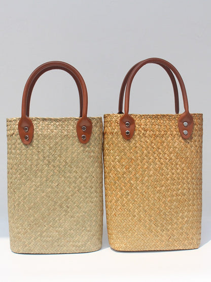 Natural straw beach tote with brown leather handles