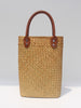 Natural straw beach tote with brown leather handles