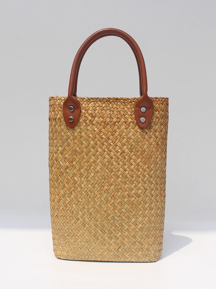 Natural straw beach tote with brown leather handles