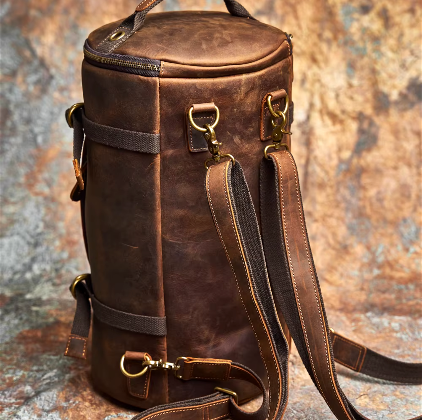 Assortment of stylish leather backpacks with sleek designs, adjustable straps, and elegant finishes, arranged on a wooden surface.