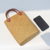 Natural straw beach tote with brown leather handles