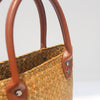 Natural straw beach tote with brown leather handles