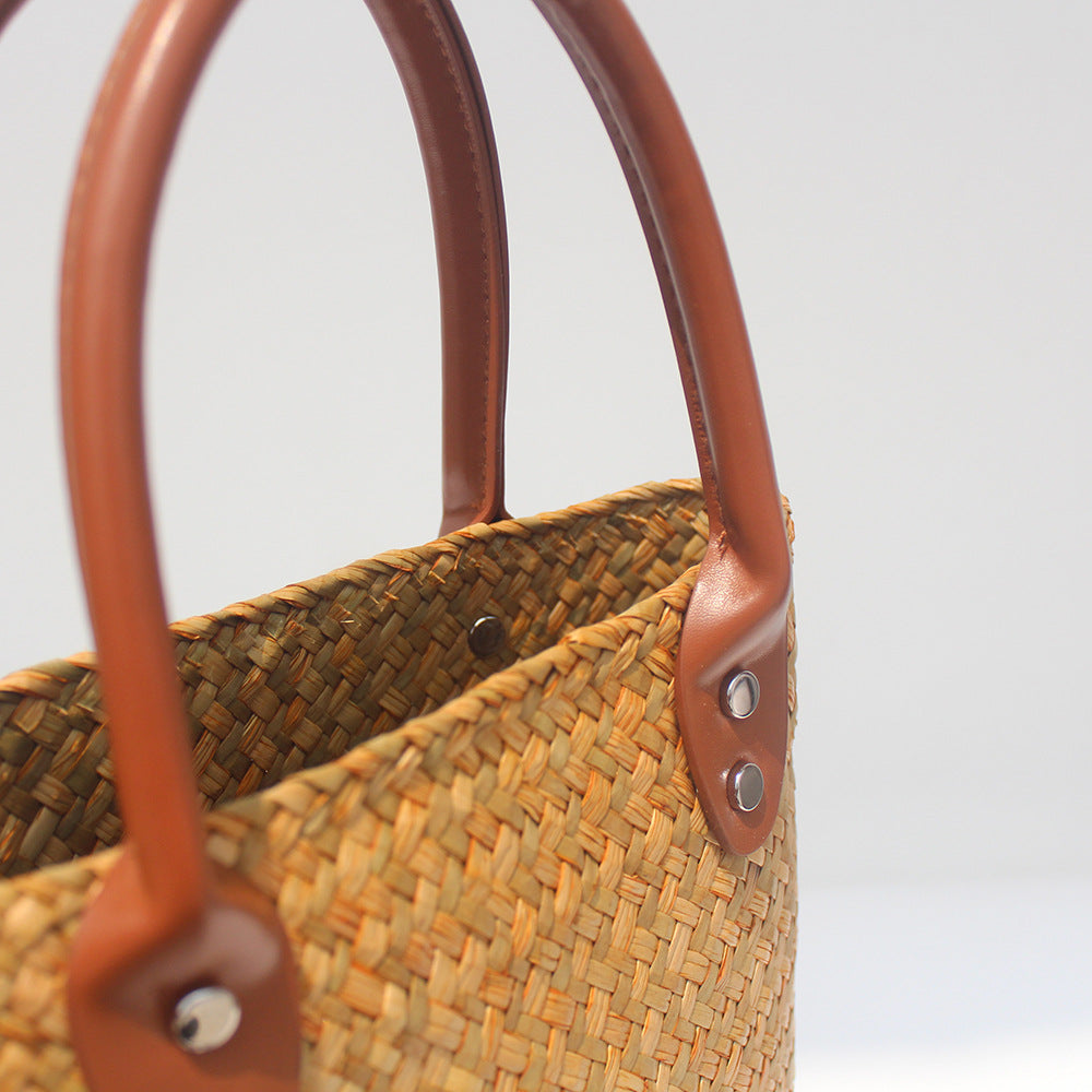 Natural straw beach tote with brown leather handles