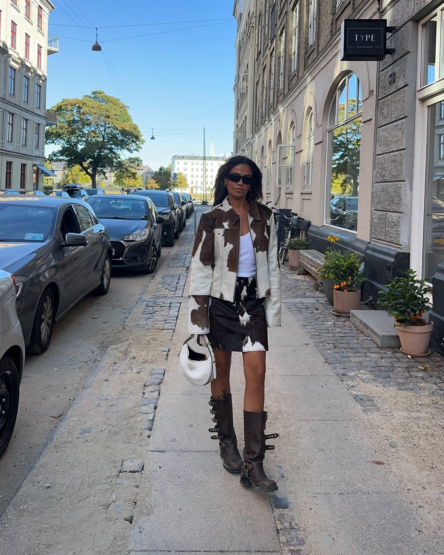 Cowgirl skirts meet modern style—this cowhide fur jacket and cow print skirt combo is perfect for street fashion or Western events.

