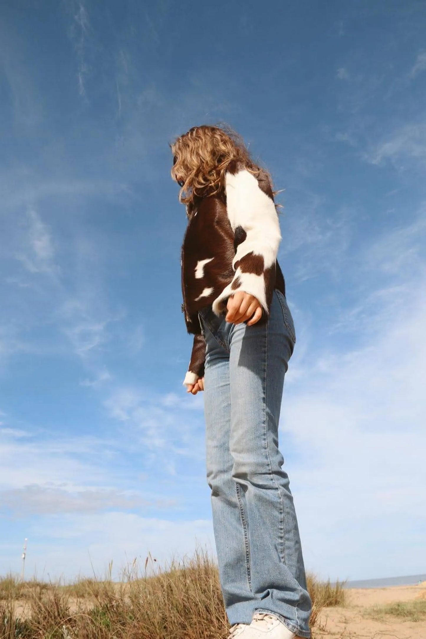 Real cow fur coat for women featuring asymmetrical hide placements and soft unlined interior—crafted from hair-on cowhide leather.