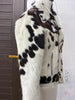 Stand out with a cowhide jacket women can wear year-round. Real hair on cow hide, tricolor design, and bold moto fit.