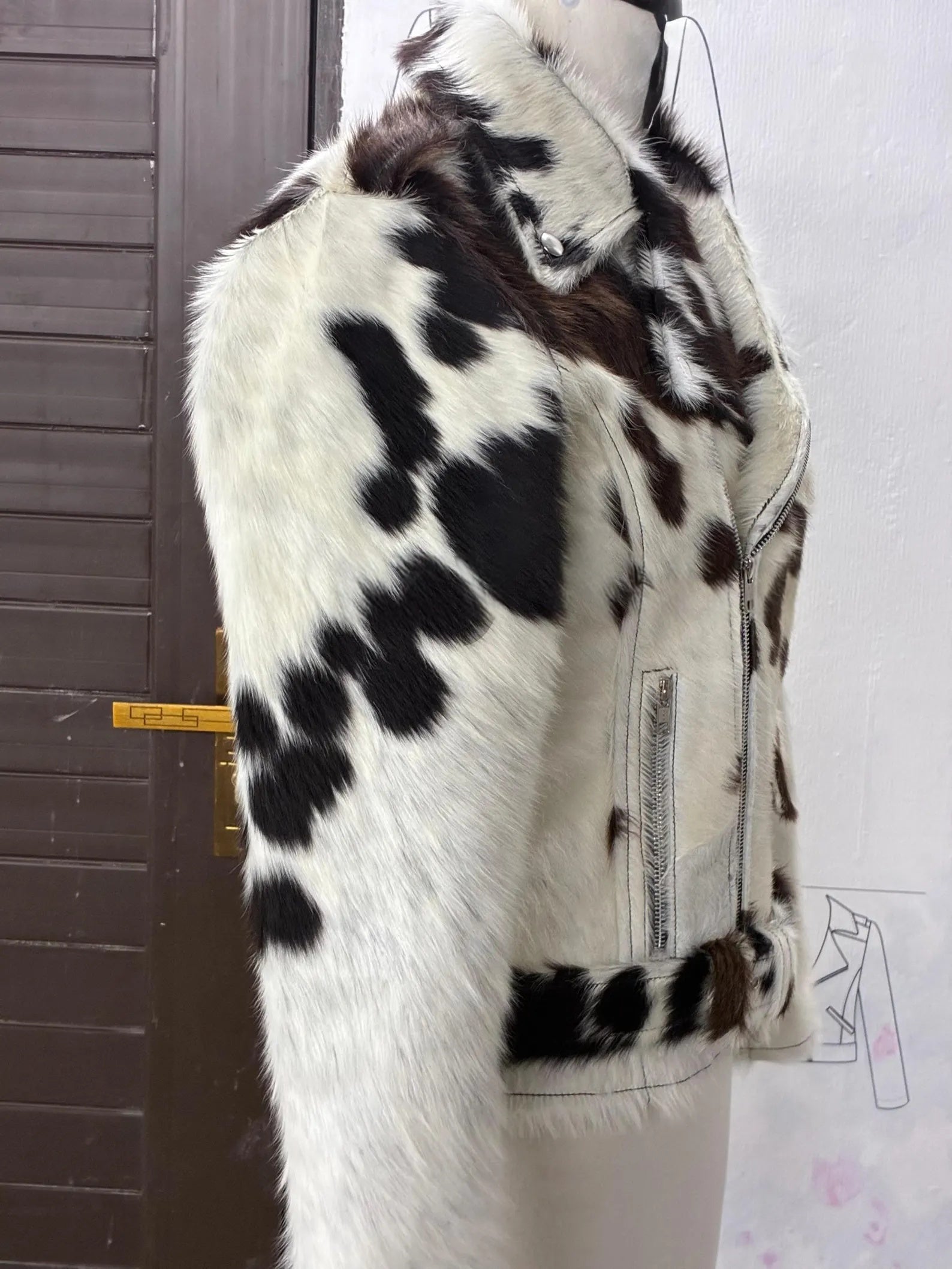 Stand out with a cowhide jacket women can wear year-round. Real hair on cow hide, tricolor design, and bold moto fit.