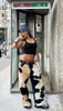 Women’s cowhide pants with real black and white cow fur and leather back. Bold cow girl outfit for western styling, rodeo events, or country streetwear.