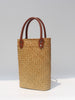 Natural straw beach tote with brown leather handles