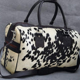 This sleek and stylish black and white hair on cowhide duffel bag is perfect for business trips or weekend getaways. Get ready to travel in style with this unique bag!