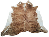 This brindle cowhide rug is the perfect addition to any room in your home. Whether it's placed in the living room, bedroom or entryway, its unique pattern and texture will add a touch of elegance to the space.