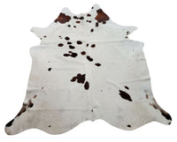 If you're looking for a large, one of a kind rug with a modern touch, look no further than the spotted cowhide rug. This soft and smooth rug is sure to make a statement in any room.