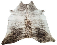  There are many different types of cowhide rugs available, from brindle to dark and natural colors. Real cowhide rugs are made from the hide of a cow, which is then tanned and processed into a durable material.
