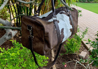 Conquer your adventures with a durable cow hide duffle bag, your trusted companion for all your travels.
