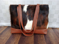 Cowhide tote bags are the perfect accessory for day-to-day use. Not only are they stylish and unique, but they can also hold everything you need for your daily errands or adventures.