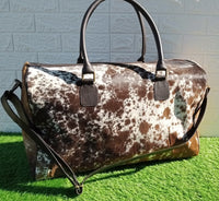 Embrace your wanderlust with our cowhide weekender bag, offering ample space and durability for your brief escapes.