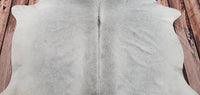 A grey cowhide rug with beautiful shine, great condition, and even thickness to cherish for casual indoor use as well as free shipping.