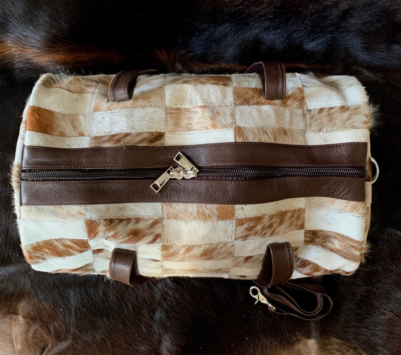 Hit the gym in fashion-forward style with this cow skin gym bag, blending functionality with urban sophistication
