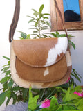 This is a beautiful cowhide bag, it is very well made and looks just like the picture, the pattern is of course a little different because it is a real hide. But I love it and am eager to show it off.
