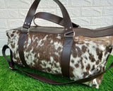 Pack your essentials in style with this exotic cowhide travel bag.