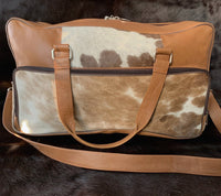 Escape in style with this cow skin weekender bag, a symbol of luxury and practicality for the modern traveler.
